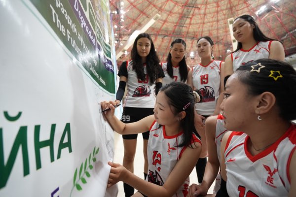 Teammates waiting their turn at the wall.