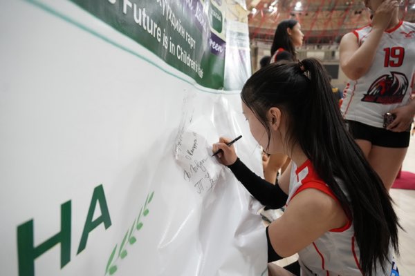 Adding a name to the wall.