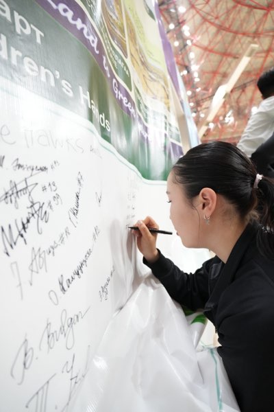 A club name and squad numbers written onto the wall.