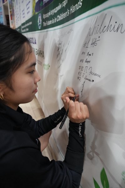 A player signs beside the squad numbers of her teammates.